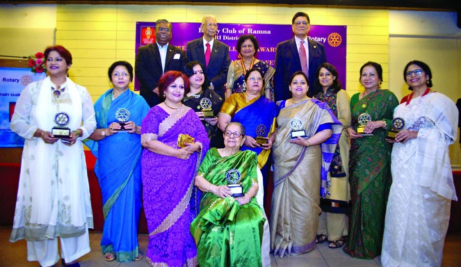 Those who were honoured pose for a photograph with guests at an award giving ceremony at the Patio Hall of Gulshan Club in the city recently.
