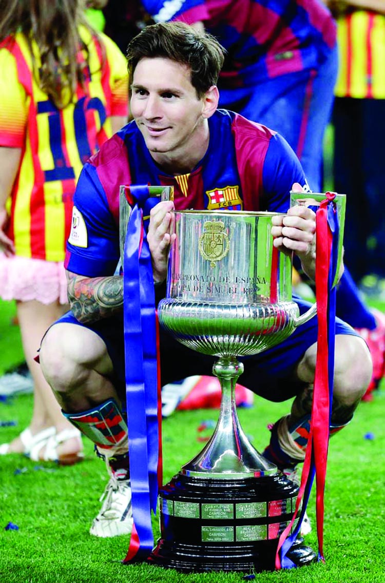 Barcelona's Lionel Messi poses with the trophy after winning the final of the Copa del Rey soccer match between FC Barcelona and Athletic Bilbao at the Camp Nou Stadium in Barcelona, Spain on Saturday.