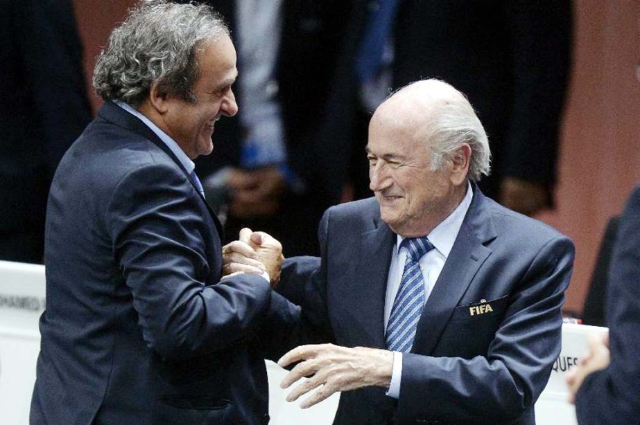 Re-elected FIFA president Sepp Blatter (right) is congratulated by FIFA vice president and UEFA president Michel Platini after his speech during the 65th FIFA Congress held at the Hallenstadion in Zurich, Switzerland on Friday (May 29, 2015). Blatter has