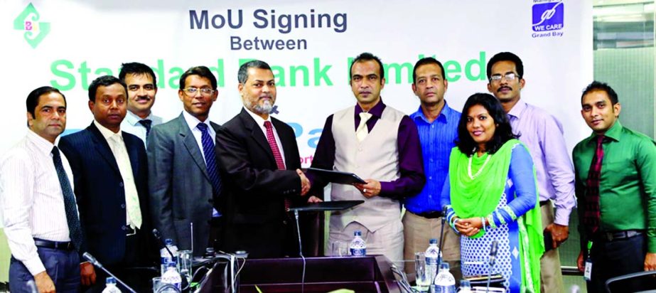 Mamun-Ur-Rashid, Deputy Managing Director of Standard Bank and Mahmud Ahmed Mamun, General Manager of Praasad Paradise Hotel & Resorts, sign a deal at Cox's Bazar recently. Under the deal, VISA cardholders and employees of the bank will get up to fifty p