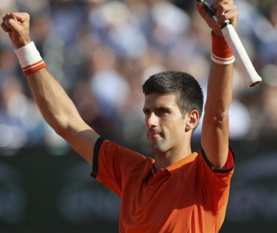 Serbia's Novak Djokovic celebrates winning the quarterfinal match of the French Open tennis tournament against Spain's Rafael Nadal in three sets, 7-5, 6-3, 6-1, at the Roland Garros stadium in Paris, France on Wednesday.