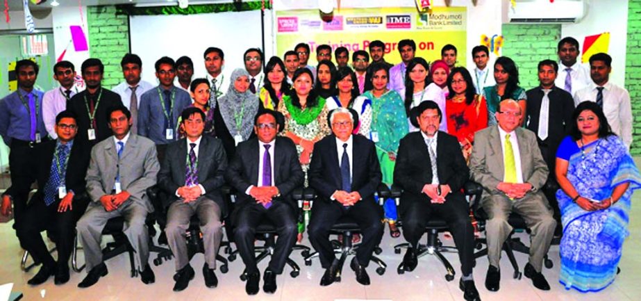 Md Mizanur Rahman, Managing Director of Modhumoti Bank Limited, poses with the participants of a daylong training program on "Operation of NRB Remittance Software" at its training institute on Thursday.