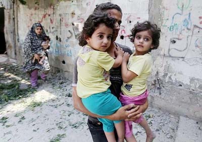 Family members flee from Gaza City's Shijaiyah neighbourhood to escape Israili air attacks