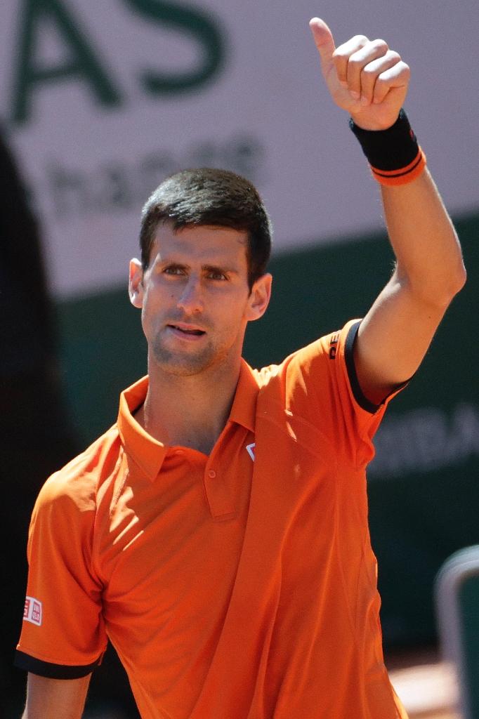 Serbia's Novak Djokovic celebrates his victory over Great Britain's Andy Murray Djokovic beats Andy Murray 6-3, 6-3, 5-7, 5-7, 6-1 at the Roland Garros 2015 French Tennis Open in Paris on Saturday.