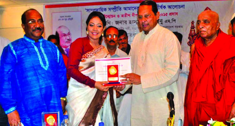 Information Minister Hasanul Huq Inu handing over Atish Dipankar Gold Medal-2015 to writer Shamim Ara Smrity for her contribution in literature at a ceremony organized by Atish Dipankar Gabeshona Parishad at a hotel in the city on Saturday.
