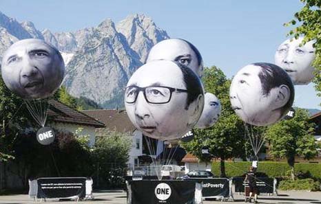 Balloons, made by the "ONE" campaigning organisation, depicting leaders of the G7 countries are inflated in Garmisch-Partenkirchen on Sunday.