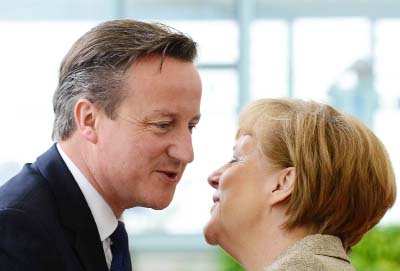 Prime Minister David Cameron, pictured greeting German Chancellor Angela Merkel ahead of talks last month, was put on notice that 50 of his backbenchers will lead calls for Britain to quit the EU if he does not secure major concessions