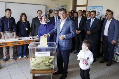 Turkish Prime Minister Ahmet Davutoglu (C) casts his ballot at a polling station during the parliamentary election in Konya, Turkey on Sunday.