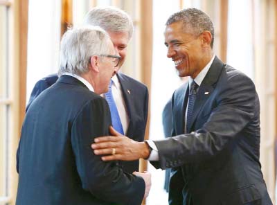 Canada's Prime Minister Stephen Harper (2nd left) and European Commission President Jean-Claude Juncker (left) greet US President Barack Obama at the G7 Summit in southern Germany on Monday.