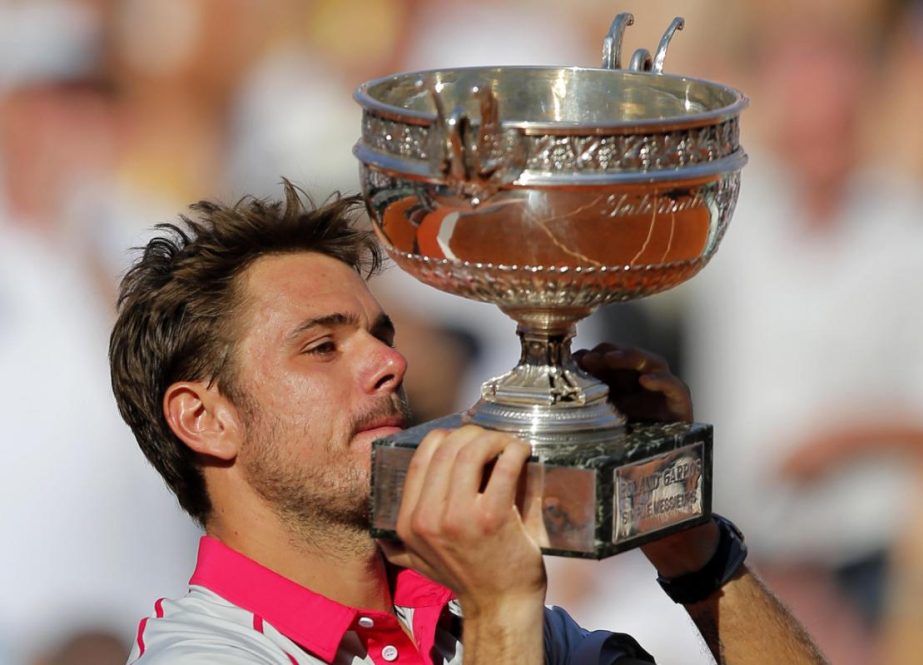Switzerland's Stan Wawrinka lifts the cup after defeating Serbia's Novak Djokovic in their final match of the French Open tennis tournament at the Roland Garros Stadium in Paris on Sunday. Wawrinka won 4-6, 6-4, 6-3, 6-4.