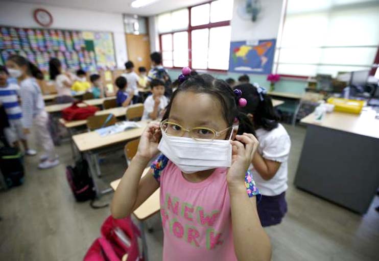 An elementary school student wears a mask to prevent contracting Middle East Respiratory Syndrome (MERS) at an elementary school in Seoul, South Korea