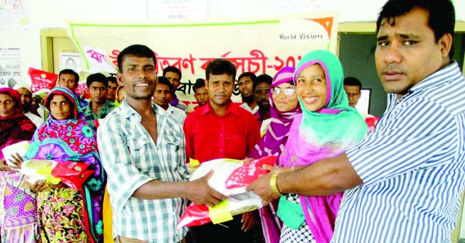 DINAJPUR: Arbindu Roy, Agricultural Officer , Fulbari , World Vision Bangladesh distributing BRRRI dhan 34 variety rice seed as Chief Guest among the extreme poor farmers in Fulbari Upazila on Monday.