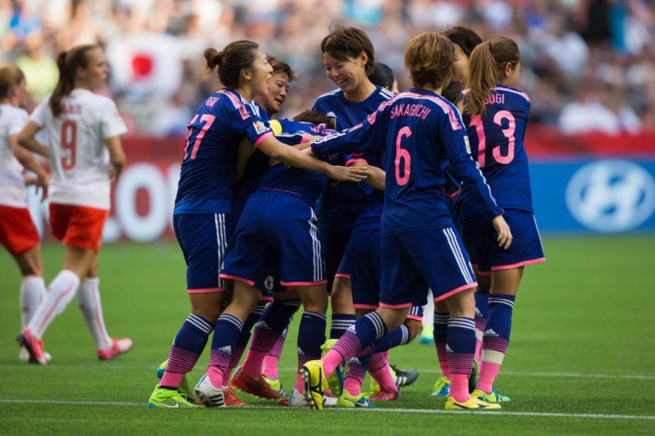 Japan's Aya Miyama (center) is congratulated by her teammates after scoring a goal against Switzerland on a penalty kick during first half FIFA Women's World Cup soccer action in Vancouver, British Columbia on Monday.