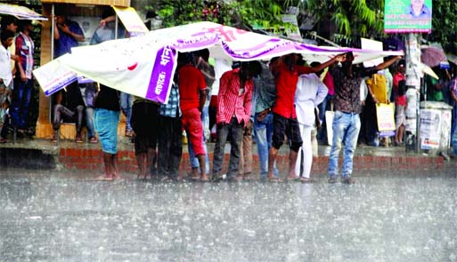 Merryment in front of Jatiya Press Club as Wednesday afternoon's brief rain brought a sigh of relief from last few days hot spell.