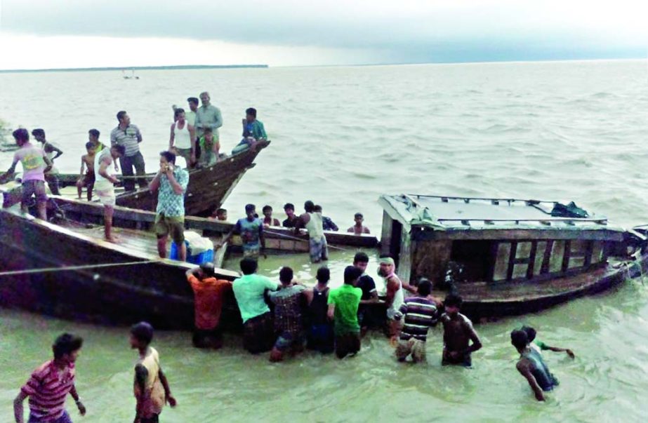 Locals of Manpura trying to rescue the trawler capsized with about 100 passengers at Meghna River in Bhola on Thursday. Eight bodies have been recovered so far.