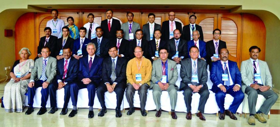 Bangladesh Bank Governor Dr Atiur Rahman, poses with the participants of a symposium on "Financial Inclusion" of SAARCFINANCE central bank's members at a city hotel on Friday.