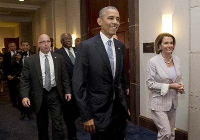 President Barack Obama, House Minority Leader Nancy Pelosi of Calif. and House Minority Assistant Leader James Clyburn of S.C., leave meeting with House Democrats on Capitol Hill in Washington on Friday.