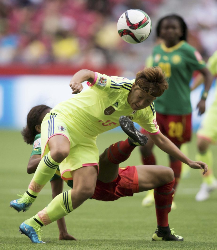 Japan's Yuika Sugasawa, front, battles Cameroon's Jeannette Yango during the first half of a FIFA Women's World Cup soccer match on Friday in Vancouver, British Columbia, Canada.