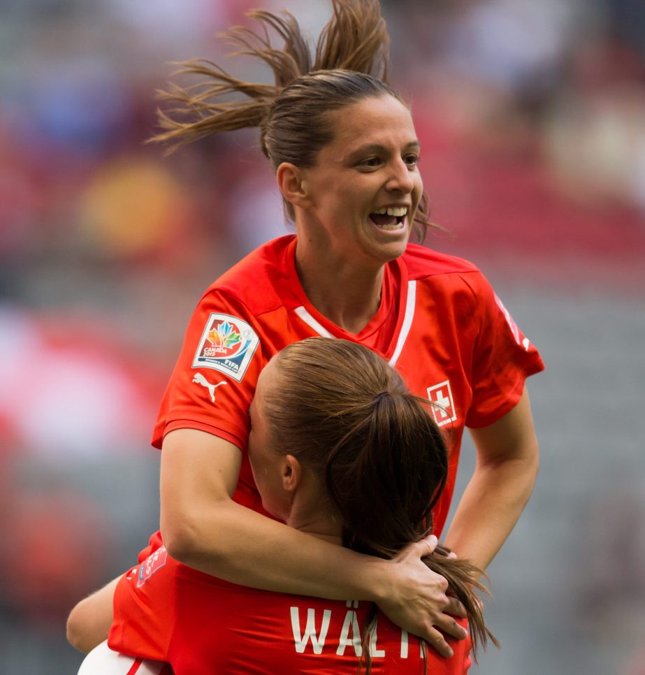Switzerland's Fabienne Humm, top, leaps into the arms of teammate Lia Waelti after scoring her second goal against Ecuador during the second half of a FIFA Women's World Cup soccer match in Vancouver, British Columbia, Canadaon Friday.
