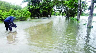 SYLHET: Roads at Goayinghat Upazila are submerged by hilly water on Saturday.