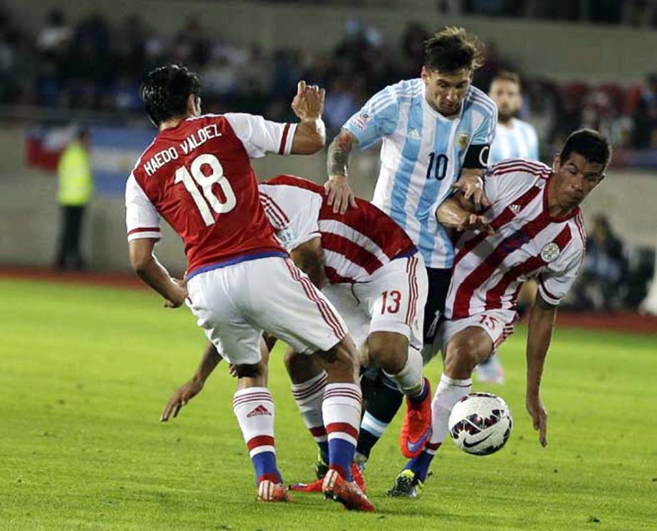 Argentina's Lionel Messi (second from right) battles against Paraguay's Victor Caceres (right) Richard Ortiz, 13, and Nelson Haedo during a Copa America Group B soccer match at La Portada stadium in La Serena, Chile on Saturday.