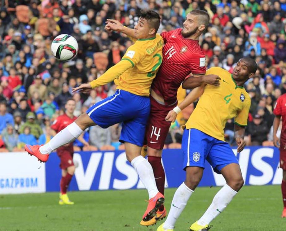 Portugal's Domingos Duarte heads the ball past Brazil's Joao Pedro (left) and Marlon (right) during their U20 soccer World Cup quarterfinal game in Hamilton, New Zealand on Sunday.