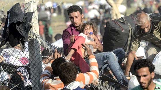 Refugees flooded through holes in the border fence before Turkish troops stepped in