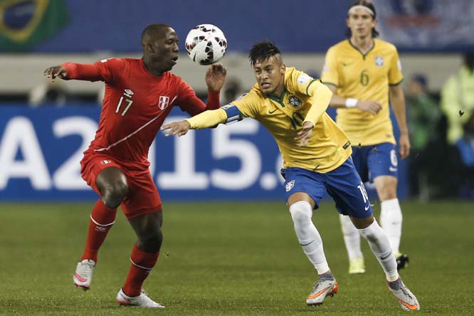 Brazil's Neymar (right) fights for the ball against Peru's Luis Advincula during a Copa America Group C soccer match at the German Becker Stadium in Temuco, Chile on Sunday.