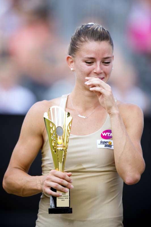 Camila Giorgi of Italy holds the trophy after winning the women's final against Belinda Bencic of Switzerland at the open grass court tournament in Rosmalen, central Netherlands on Sunday.