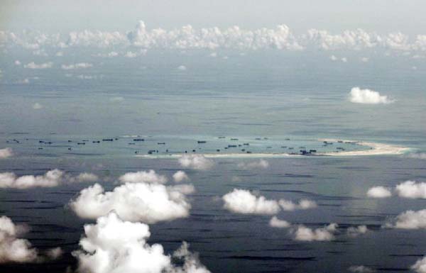 Chinese dredging vessels are purportedly seen in the waters around Mischief Reef in the disputed Spratly Islands in the South China Sea in this still image from video taken by a P-8A Poseidon surveillance aircraft provided by the United States Navy .