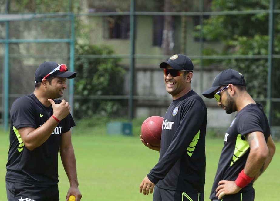 Suresh Raina and MS Dhoni find a reason to laugh in front of Virat Kohli during their practice session at Mirpur on Wednesday.