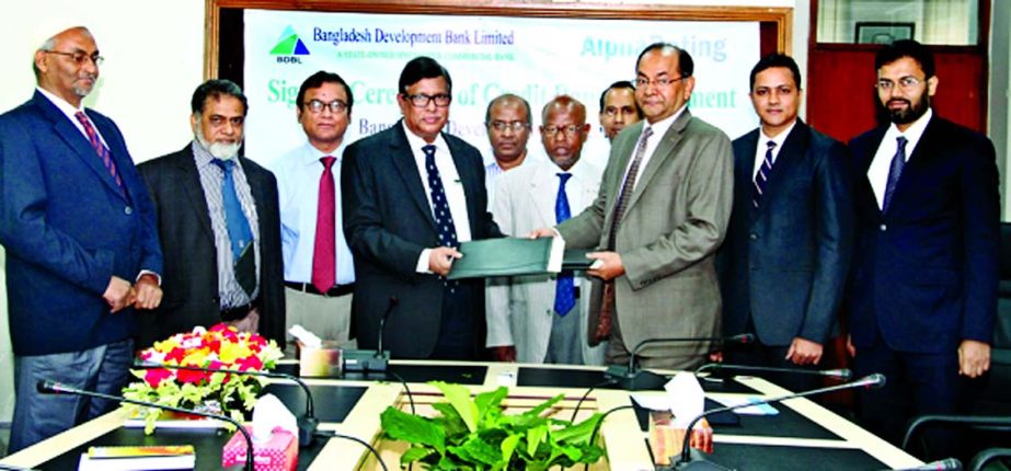 Bangladesh Development Bank Limited Managing Director Dr Md. Zillur Rahman and Alpha Credit Rating Limited Managing Director Muhammed Asadullah exchanging agreed documents for conducting bank's credit rating on Thursday. Officials from both the sides wer