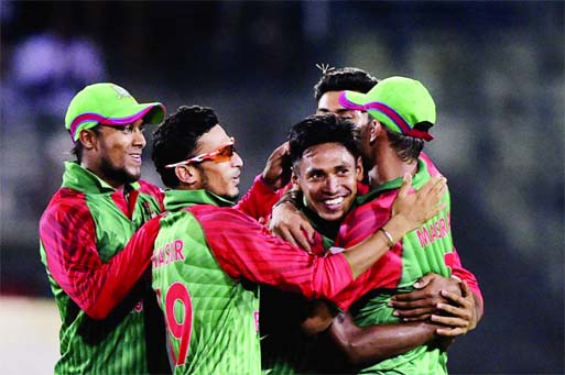 Mustafizur Rahman is mobbed by his team-mates after dismissing Ajinkya Rahane during the 1st ODI between Bangladesh and India at Mirpur on Thursday.