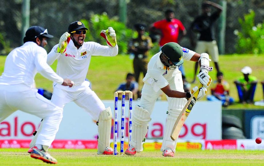 Azhar Ali is trapped in front by Rangana Herath during the 3rd day of the 1st Test between Sri Lanka and Pakistan at Galle on Friday.