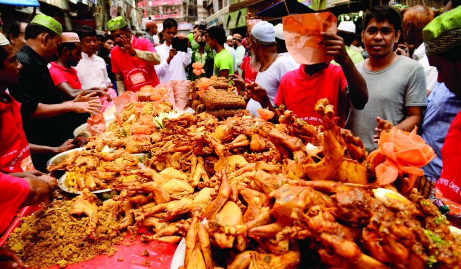 People gather at Chawkbazar open market to buy traditional iftar items on the first day of Ramzan on Friday.