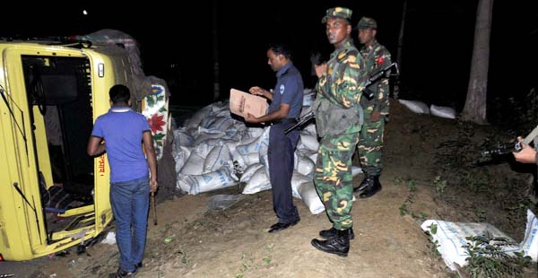 A sugar-laden truck overturned at Manu Tek point on Bandarban-Chittagong Highway yesterday.