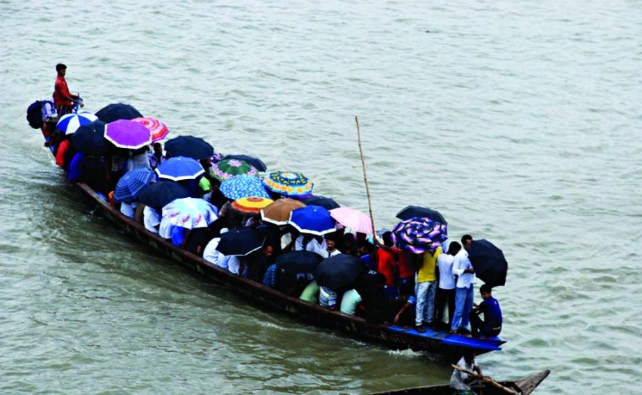 Taking life risk, a wooden boat overloaded with passengers and goods passing through the turbulent Buriganga River amid Sunday's stormy rain taking the advantage in absence of BIWTA men's vigil.