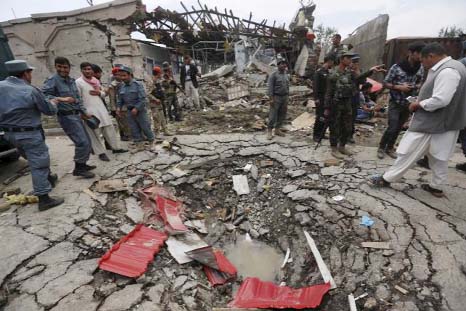 Members of Afghan security forces stand at the site of an attack near the Afghan parliament in Kabul, Afghanistan.