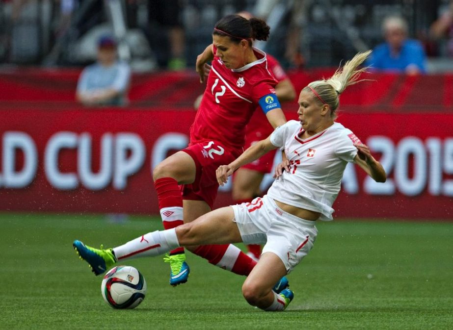 Canada forward Christine Sinclair (L) and Switzerland forward Lara Dickenmann fight for the ball during their Women's World Cup match at BC Place Stadium in Vancouver on Sunday.