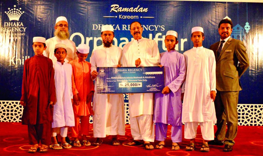 Shahid Hamid FIH, Executive Director of Dhaka Regency, handing over cheque to Khilkhet Bottola Islamia Madrasha and Atimkhana and hosted Iftar for orphanage at the hotel recently.