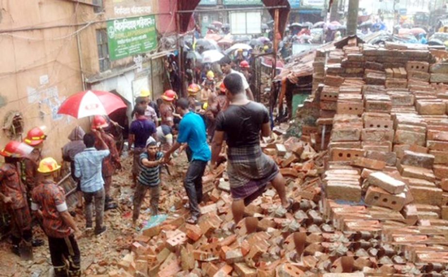 A boundary wall of Railway collapsed beside the Abrar Hotel in East Madarbari due to heavy downpour for the last two days on a street in Chittagong collapsed on Tuesday morning .