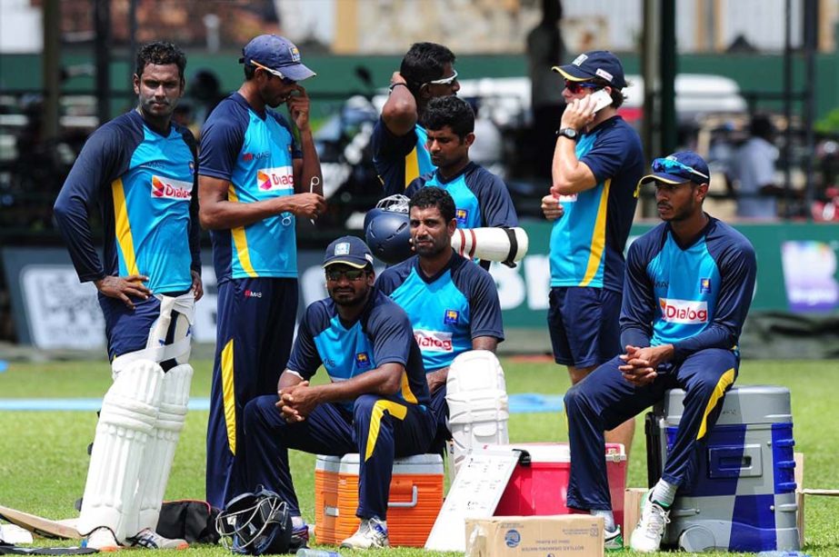 Sri Lanka's cricket captain Angelo Mathews (L) and teammates take a rest during a practice session at the P. Sara Oval Cricket Stadium in Colombo on Wednesday ahead of a second Test match against Pakistan today (June 25).