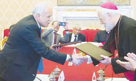 Palestinian Foreign Minister Riad al-Malki shakes hands with Vatican's State Relations Secretary Paul Rechard Gallagher after they signed the historic accord in Vatican city on Friday.