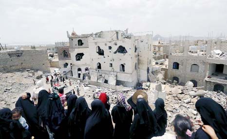 People look at the rubble of houses destroyed by a Saudi-led air strike in Yemen's capital Sanaa.