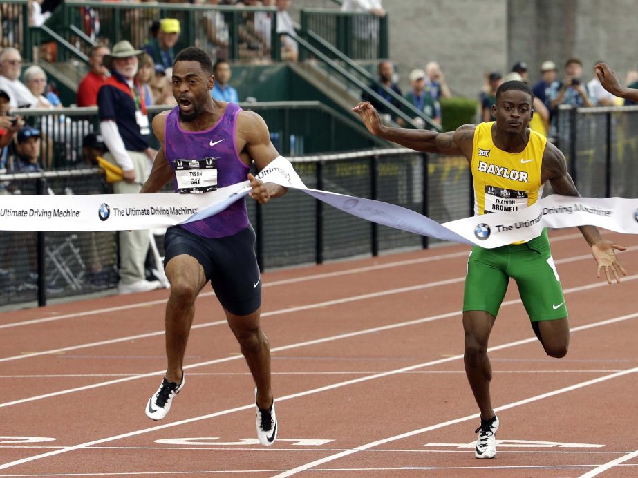 Tyson Gay (left) hits the tape ahead of Trayvon Bromell to win the 100-meter final at the US Track and Field Championships in Eugene, Ore on Friday.