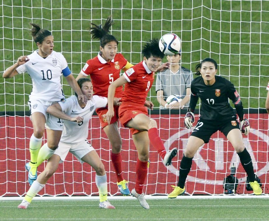 China's Wang Shanshan (9) clears the ball as teammates Wu Haiyan (5) and keeper Wang Feiand, and United States' Carli Lloyd (10) and Kelley O'Hara (5) watch during the first half of a quarterfinal match in the FIFA Women's World Cup soccer tournament