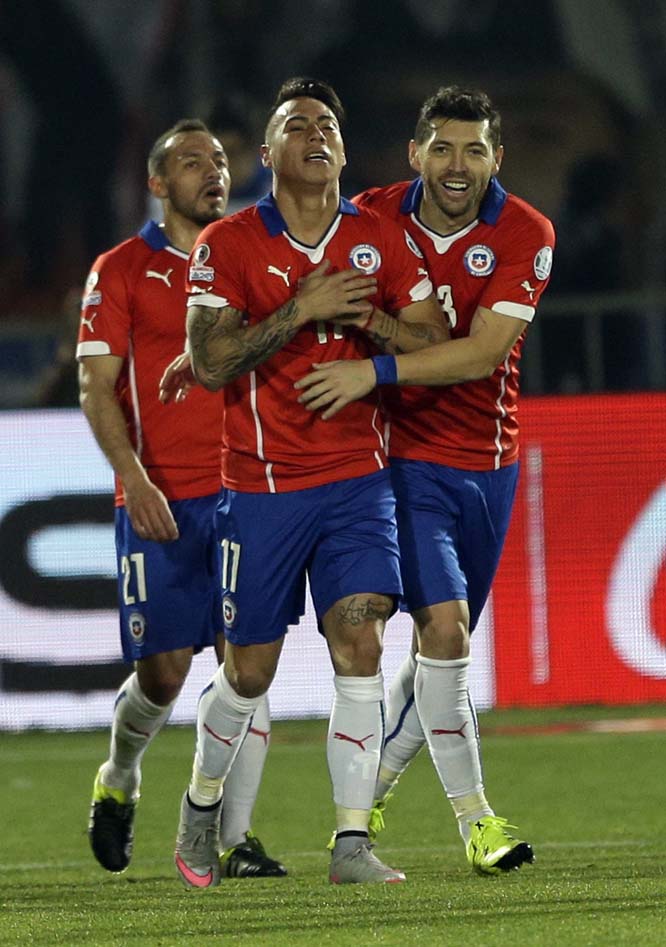 Chile's Eduardo Vargas celebrates with teammates after scoring his team's first goal during a Copa America semifinal soccer match at the National Stadium in Santiago, Chile on Monday.