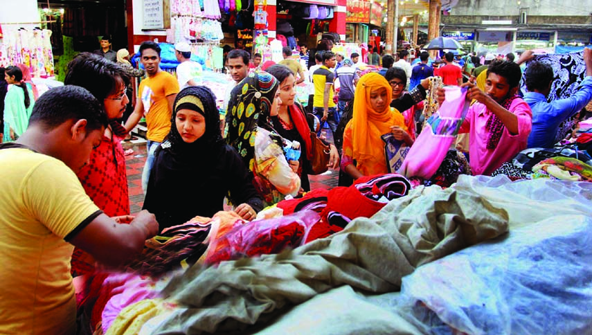 Eid shoppersâ€™ rush in city footpaths near New Market area on Wednesday.