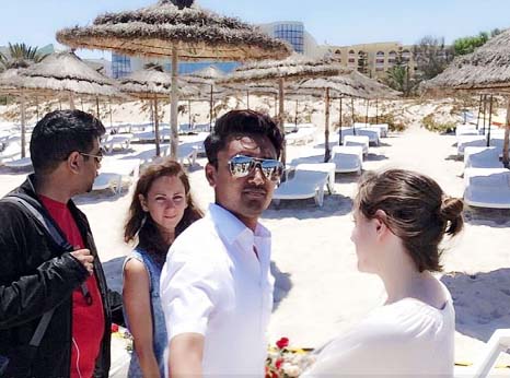 With the sun loungers where dozens tourists were slaughtered clearly visible in the background, the former NHS worker looked directly at the camera in aviator-style sunglasses surrounded by four friends.