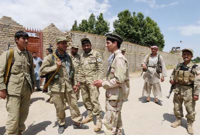 Afghan Local Police (ALP) commander Mohammad Jawad (3rd R) talks to members of his unit in Kasab village in Kunduz